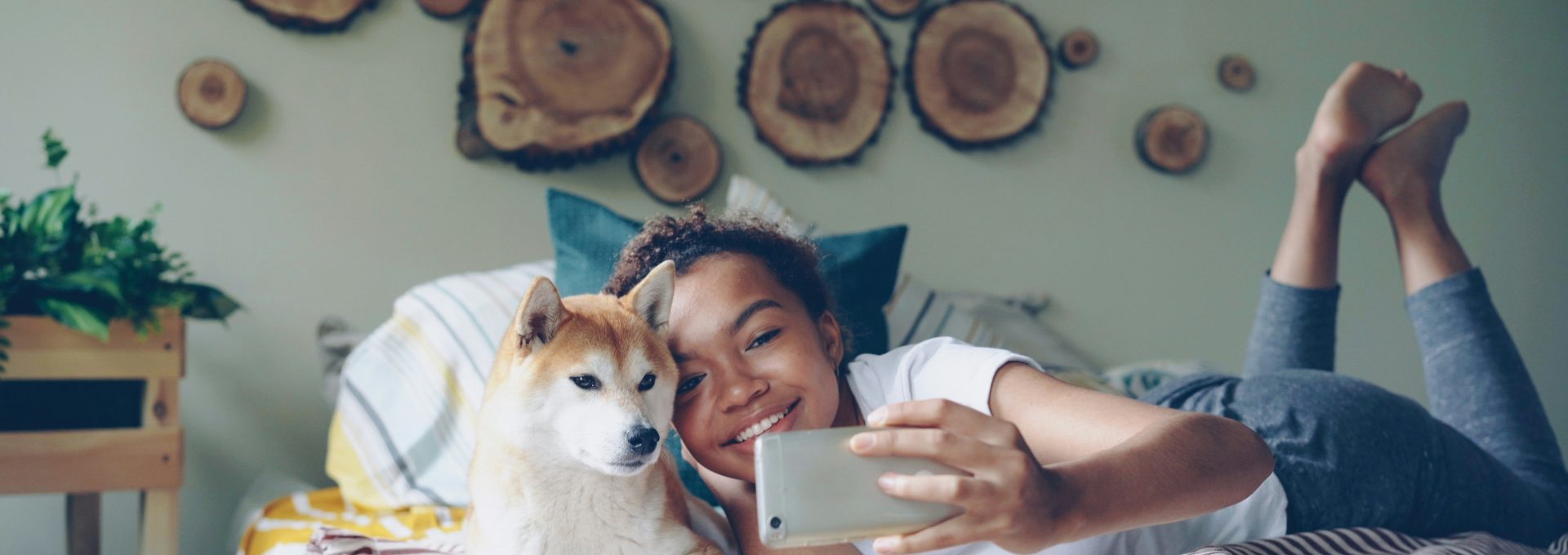 Woman and dog take a selfie in bed.